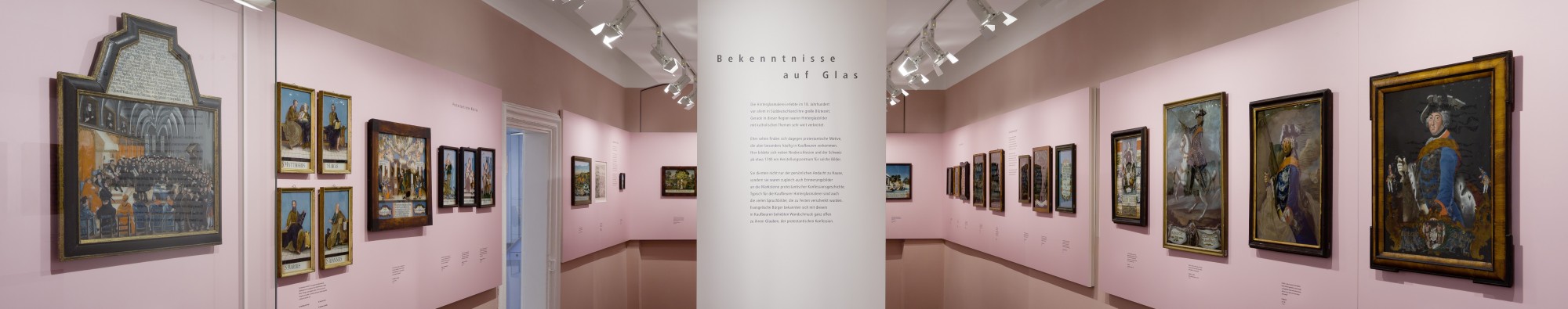 Blick in den Raum der Hinterglasbilder: rechts und links Hinterglasbilder an der Wand, in der Mitte ein Ausstellungstext.